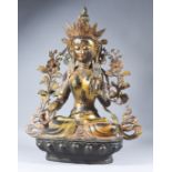 A Tibetan Bronze of Tara, with gilt detail, on lotus base, with cast stamp, 26.25ins (66.6cm) high