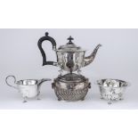 A George V Bachelor's Silver Three-Piece Tea Service, and a Late Victorian Silver Oval Tea Caddy,