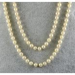 A String of Cultured Pearls, Modern, 880mm overall, with 9ct gold garnet set clasp, gross weight