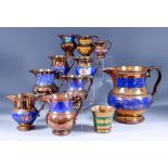 A Staffordshire Copper Lustre Jug, 19th Century, and Fourteen Other Copper Lustre Jugs and Bowls,