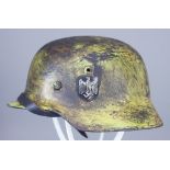 A German World War II Helmet, painted, with single decal Provenance: Special Auction Services