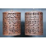 A Pair of Eastern Pierced Steel Cylindrical Hanging Candle Lanterns, decorated with figures on