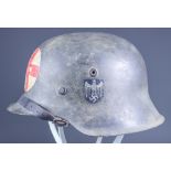 A Rare German World War II M42 Deutsche Rotes Kreuz Helmet, with hand painted red cross to front and