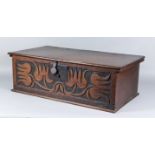 An Oak Box, Late 17th / Early 18th Century, the front carved with stylised tulips, 26ins wide x 14.