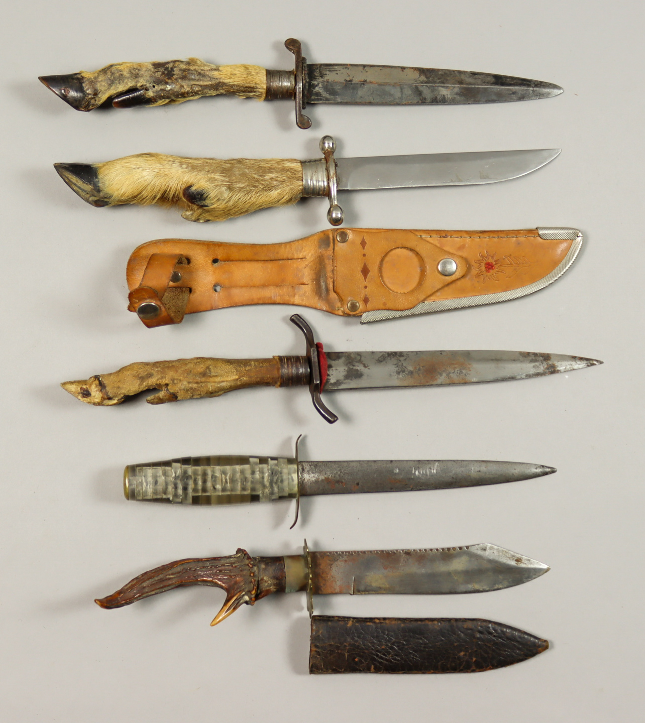 Nine Continental 20th Century Hunting Knives, five with leather scabbards