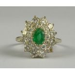 An Emerald and Diamond Cluster Ring, Modern, 18ct gold set with a centre emerald, approximately .