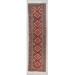 A Tekke Turkmen Runner, Early 20th Century, woven in colours of wine, navy blue, ivory and fawn,