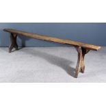A 19th Century Elm Bench of Rustic Design, on shaped end supports, 90ins x 7.25ins x 20ins high