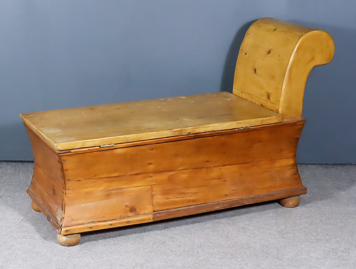 A Continental Pine Scroll End Chaise Longue/Coffer, with incurved sides on bun feet, 48ins long x
