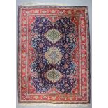 An Eastern Carpet of Tabriz Pattern, woven in colours with central lozenge shaped medallion and