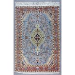 A Qum Rug, Early to Mid 20th Century, woven in pastel shades with a central floral pole medallion on