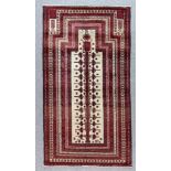 A Meshad Belouch Rug, Early 20th Century, woven in colours of wine, navy blue and fawn, with a