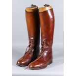 A Pair of Brown Leather Riding Boots, and an Old Leather Saddle, the riding boots with a pair of