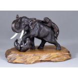 A Japanese Brown Patinated Bronze Group of an Elephant Battling Two Tigers, Meiji Period, by