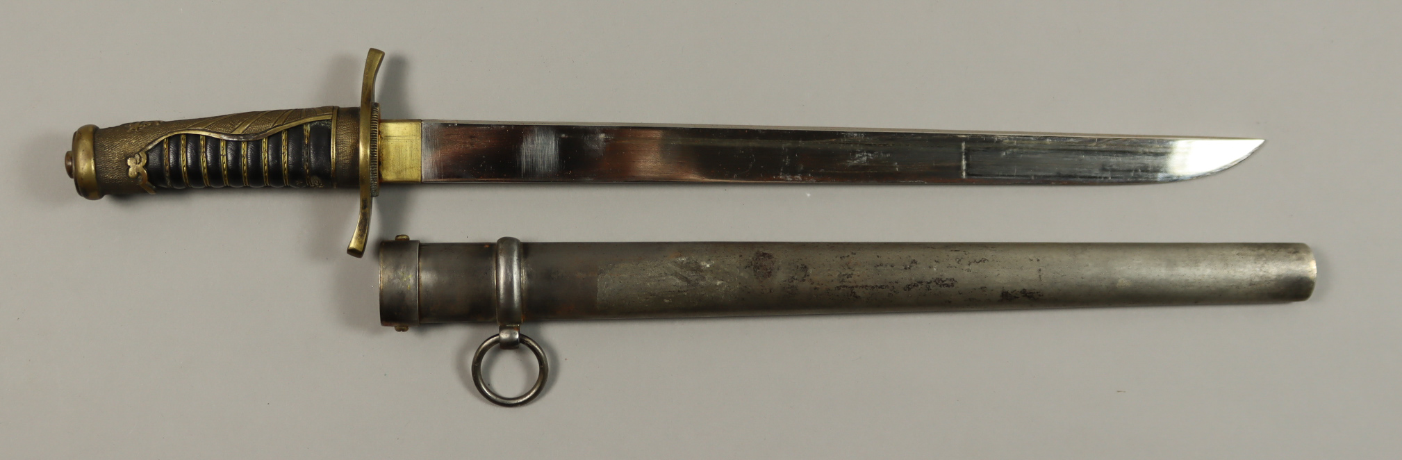 A Japanese Naval Dirk, silver and metal scabbard, rising sun pattern on hilt and backstrap, stylized