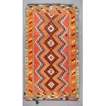 A Qashqai Kilim, Early 20th Century, woven in colours of navy blue, ivory and rose, with a six