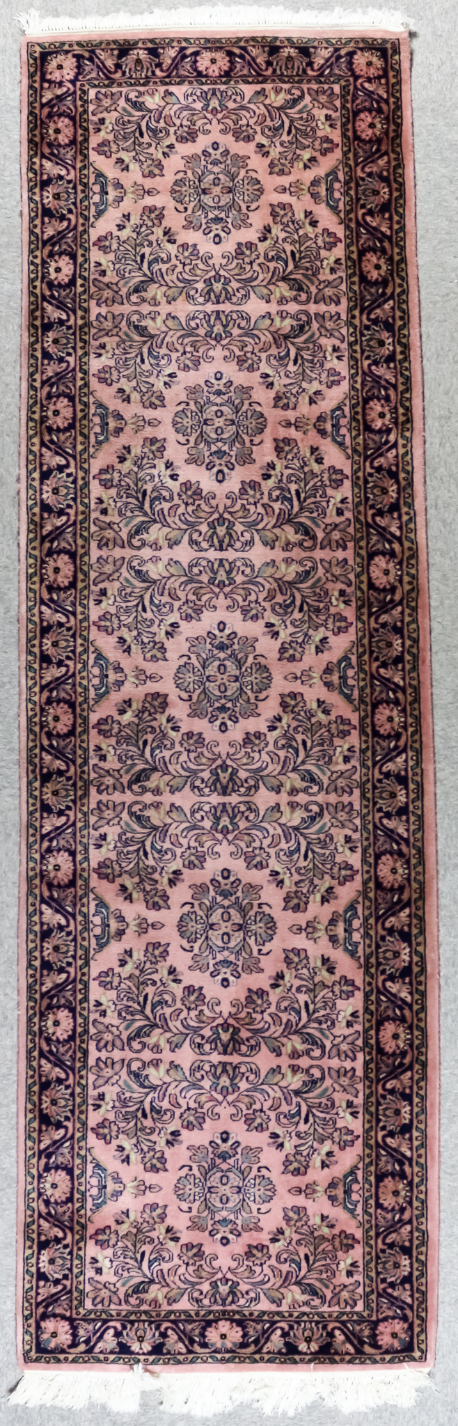 A Sarough Runner, Mid 20th Century, woven in colours, with five stylized flowerheads, the field