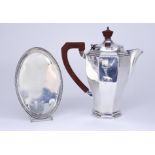A George V Silver Octagonal Hot Water Jug and a George III Silver Oval Tea Pot Stand, the hot