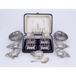 A Pair of Late Victorian Silver Butter Shells, a Set of Four George V Silver Toast Racks, and