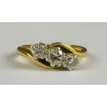 A Three Stone Diamond Crossover Ring, Modern, 18ct gold set with three brilliant cut round diamonds,
