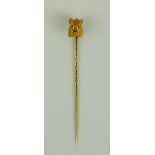 A Stick Pin, Early 20th Century, the finial with yellow metal boar's head on a 14ct gold stick