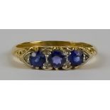 A Sapphire and Diamond Ring, Modern, 18ct gold, set with three sapphires approximately .75ct,