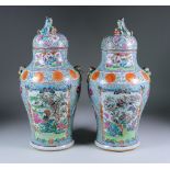 A Pair of Chinese "Cantonese" Porcelain Baluster-Shaped Vases and Covers, 19th Century, enamelled in