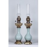 A Pair of Celadon Glazed Pottery and Brass Mounted Oil Lamps, 19th Century, with clear reeded