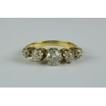 A Five Stone Diamond Ring, 20th Century, 18ct gold set with five graduated brilliant white diamonds,