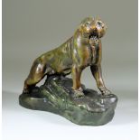 After Thomas Francois Cartier (1879-1943) - Bronzed metal figure of a lioness on a rocky mound,