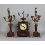 A Late 19th Century French Rouge Marble Clock Garniture, the clock with 3.5ins dial with Arabic
