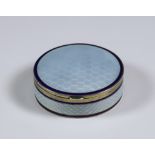 An Early 20th Century Continental Silver Gilt and White Enamel Circular Box, with import mark for