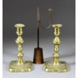 A Pair of English Brass Candlesticks, Mid 18th Century, 7.25ins high, and a wrought iron rush nip on