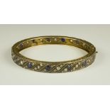 A Gilt Metal Bracelet, Early 20th Century, set with fourteen faceted sapphires and approximately