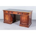 A Victorian Mahogany Kneehole Desk, with moulded edge and leather inset to top, fitted three