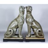 A Pair of Chinese Resin Figures of Seated Panthers in the Art Deco Manner, on rectangular bases,