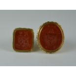 Two Carved Seal Pendants, Modern, yellow metal each with carved carnelian stone showing coat of