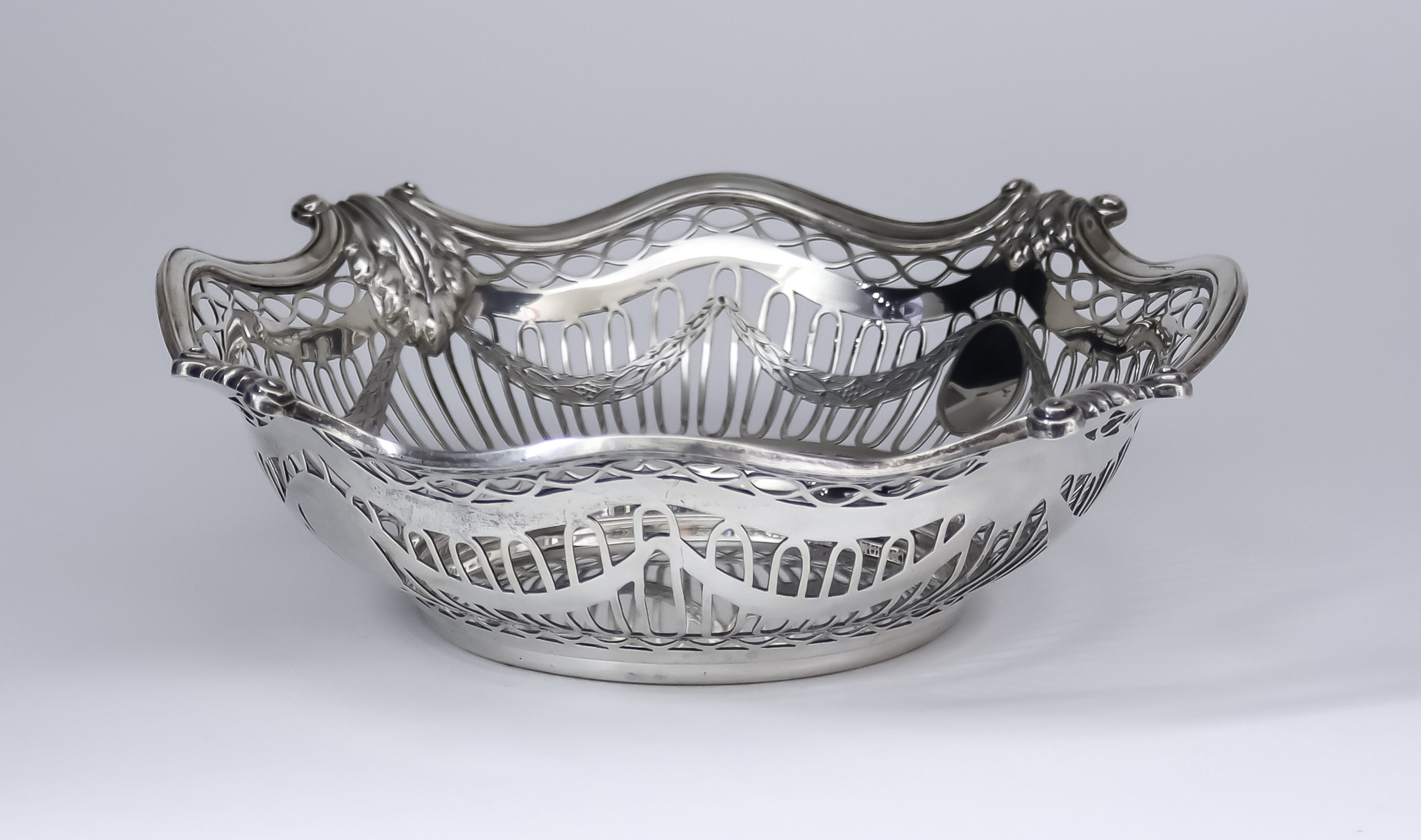 An Edward VII Silver Circular Basket, by Sibray, Hall & Co Ltd., London 1902, and retailed by Walter