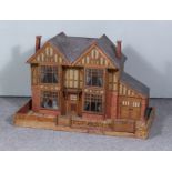 A 20th Century Wood and Paper Timber Framed Double Fronted Doll's House, with side garage, 36ins