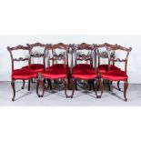 A Set of Eight Victorian Mahogany Dining Chairs, each with shaped and moulded crest rails and