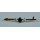 A Sapphire and Diamond Bar Brooch, set with a centre sapphire stone, approximately .50ct flanked
