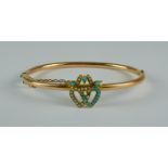 A 15ct Sweetheart Bangle, 20th Century, 185mm circumference, with two entwined hearts set with