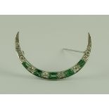 A Diamond and Emerald Crescent Brooch, Modern, silvery metal set with five emeralds, approximately