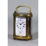 An Early 20th Century French Oval Carriage Clock with Alarm, the white enamel dial with Roman