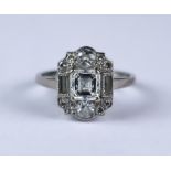 A Diamond Cluster Ring, 20th Century, in white metal mount, set with a centre cushion cut diamond,