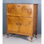 A 1950's Walnut Cocktail Cabinet, with crossbanded top and front enclosing mirrored interior, the