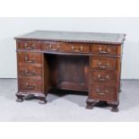 An Early 20th Century Mahogany Kneehole Desk of "Georgian" Design, of serpentine outline, inset with