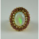 An Opal, Ruby and Diamond Cluster Ring, 20th Century, 18ct gold set with a central opal