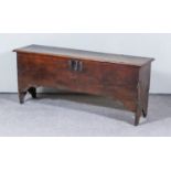 A 17th Century Oak Coffer of Narrow Proportions, with single plank top and moulded edges, on
