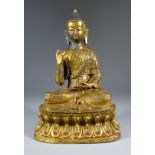 An Indo Chinese Gilt Bronze Figure of the Seated Buddha, 20th Century, his right hand raised in